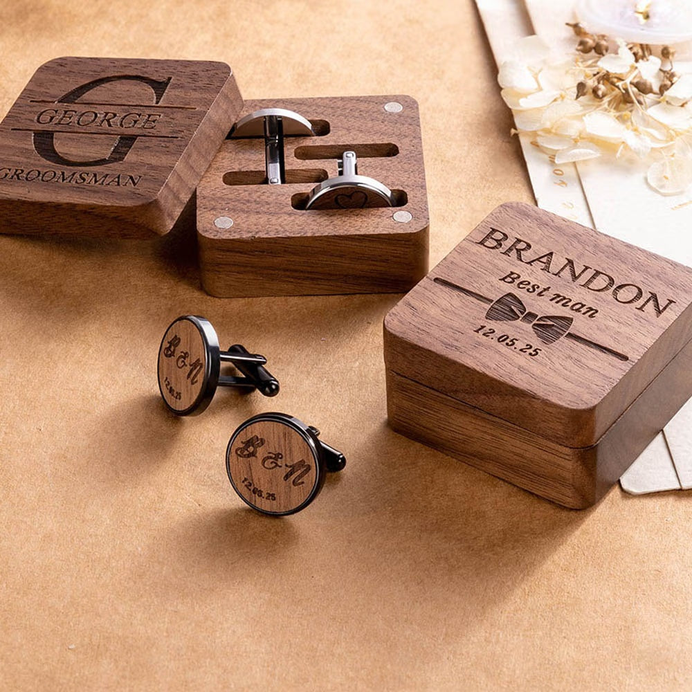 Personalized groomsman cufflinks and engraved walnut boxes displayed as wedding gifts