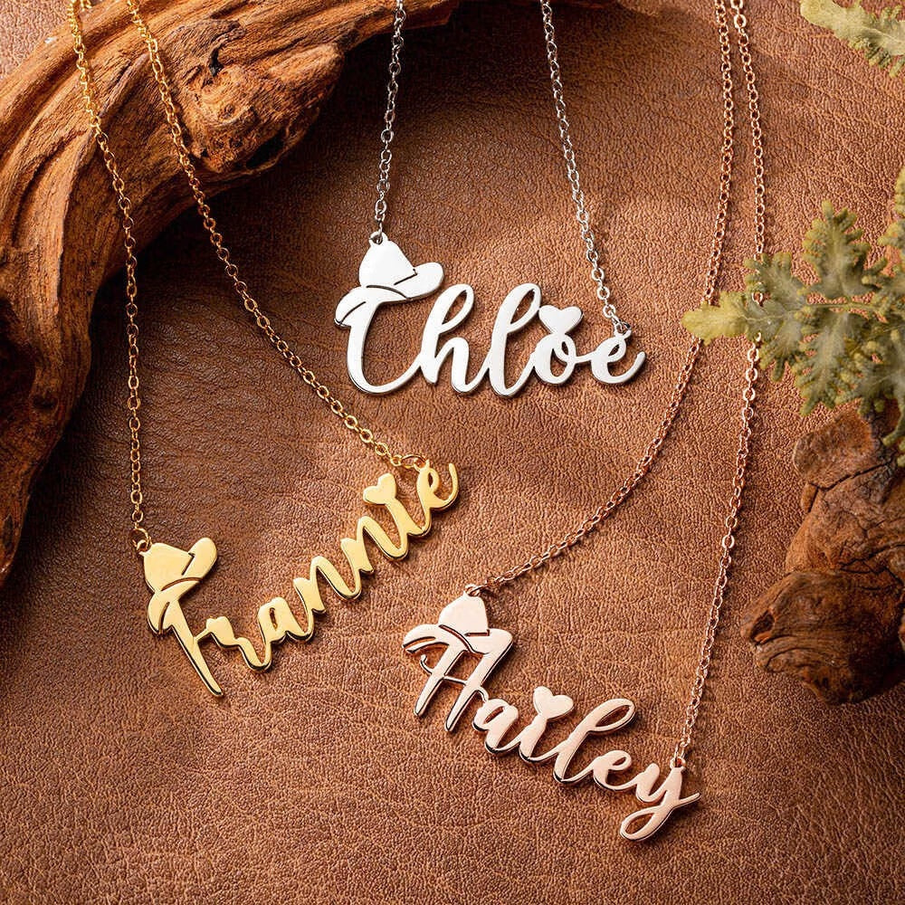 Personalized cowboy name necklaces in silver and gold finishes on rustic leather