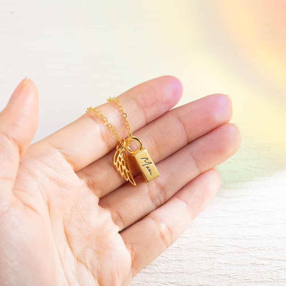 Tiny personalized urn pendant for ashes held in hand