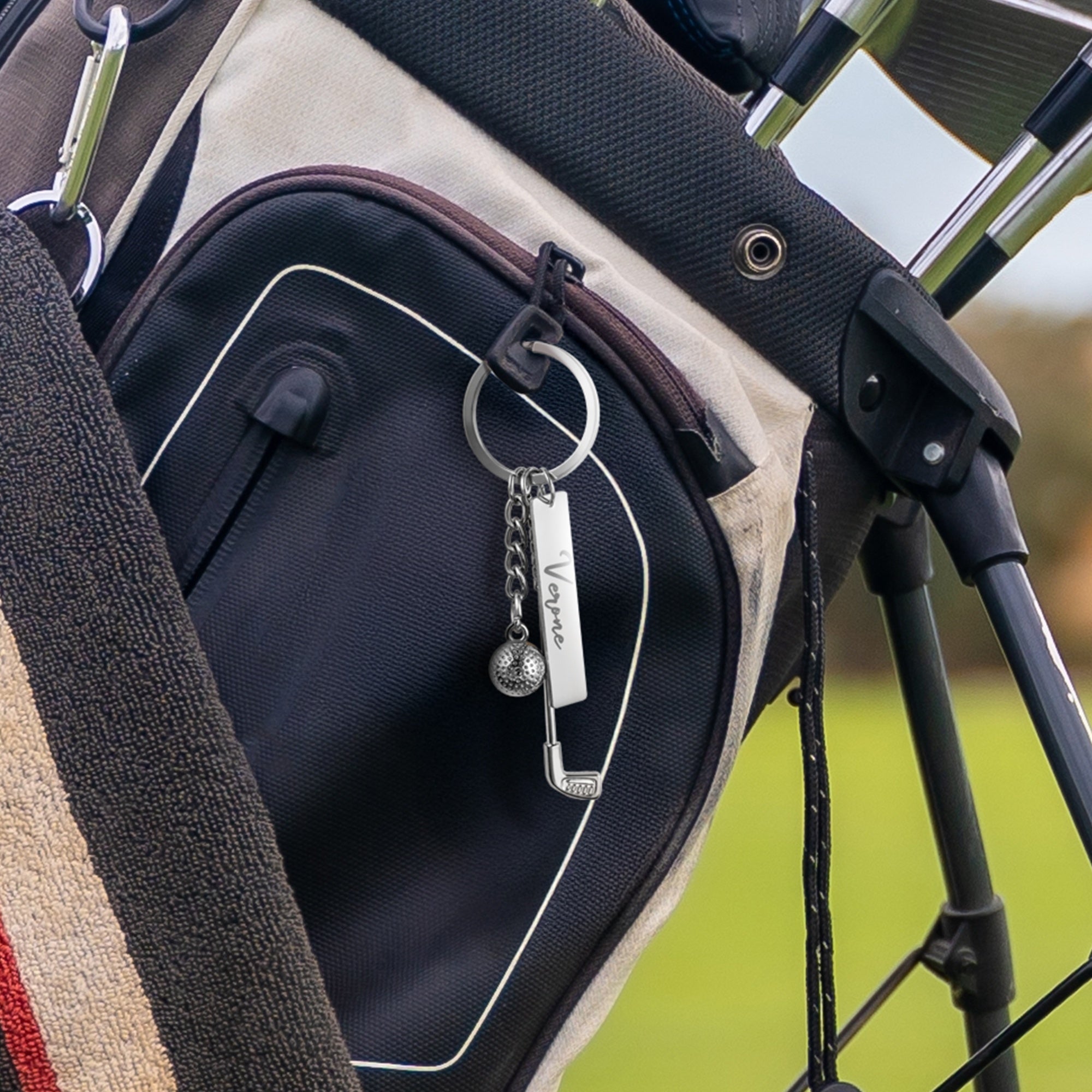 Personalized golf keychain attached to a golf bag as a custom golf accessory