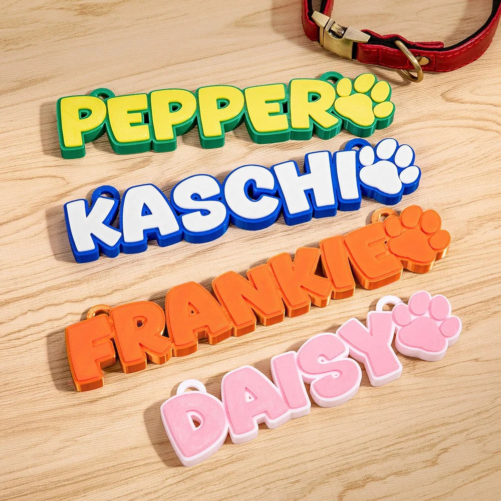 Custom pet name tags with paw prints in colorful 3D letters for dog collars