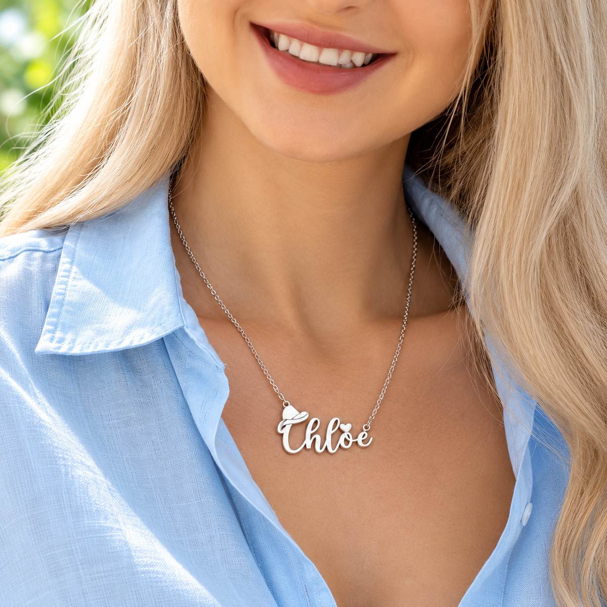 Woman wearing a personalized name necklace with cowboy hat pendant