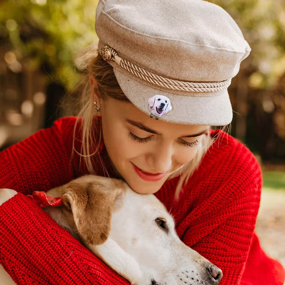 Woman wearing personalized pet photo golf ball marker on hat while holding her dog