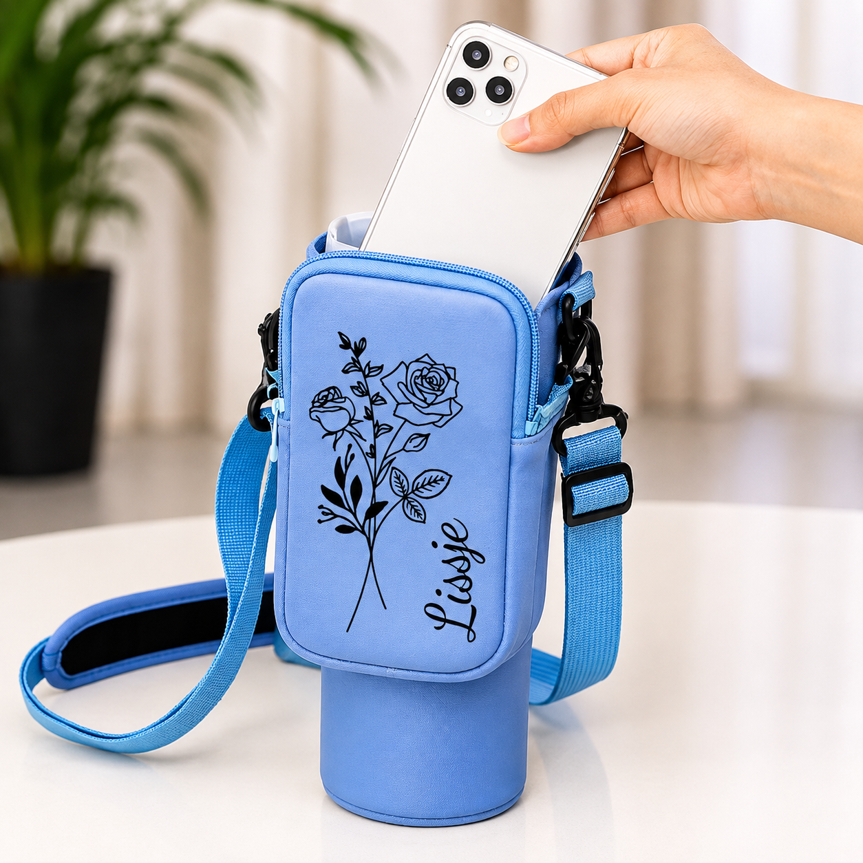Blue personalized tumbler carrier bag with zippered phone pocket and adjustable strap