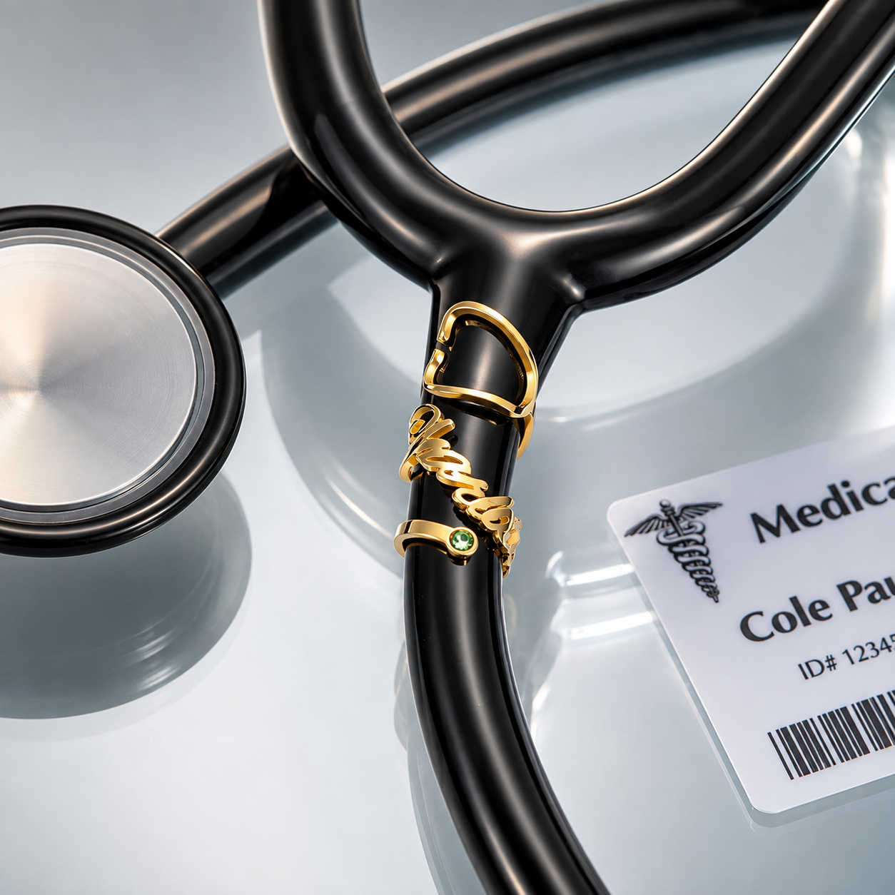 Gold personalized birthstone stethoscope name tag attached to black stethoscope