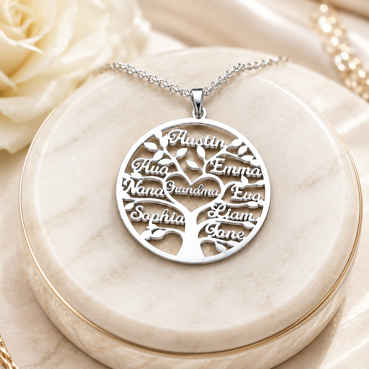 Silver personalized family tree necklace with custom names on a cream stand
