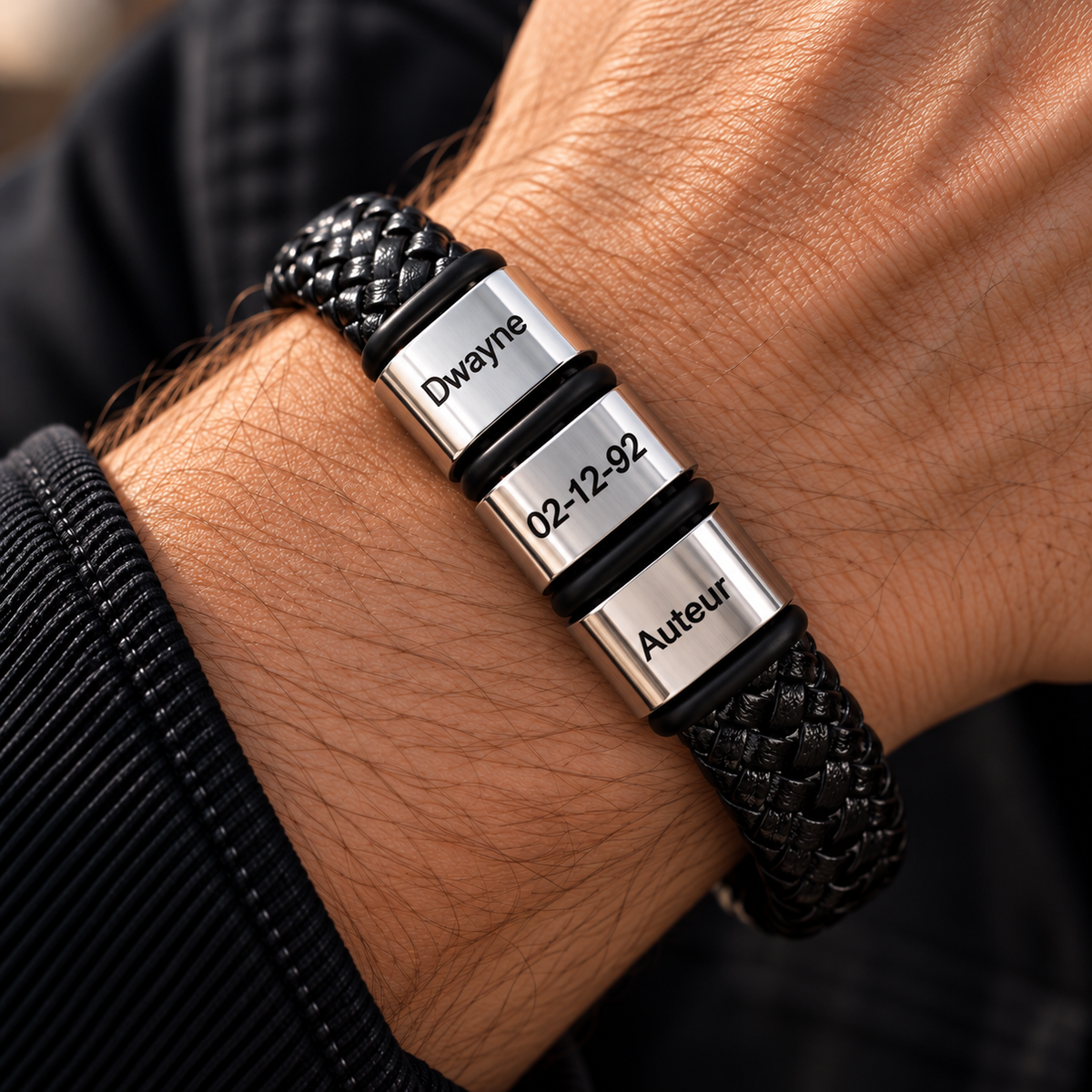 Personalized black braided leather bracelet for men with stainless steel beads engraved with family names and a special date.