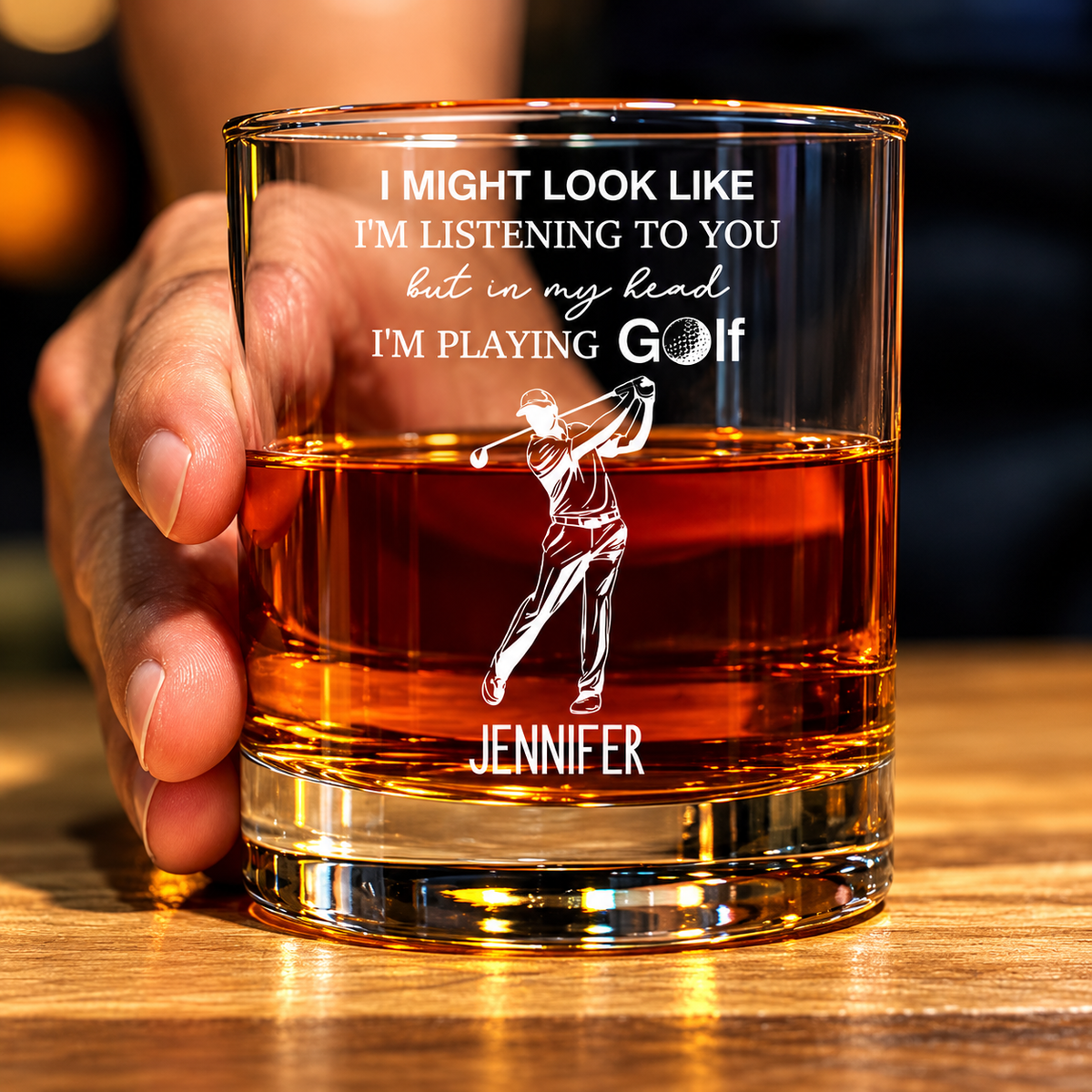Personalized golf glass with engraved golfer design and custom name held in hand