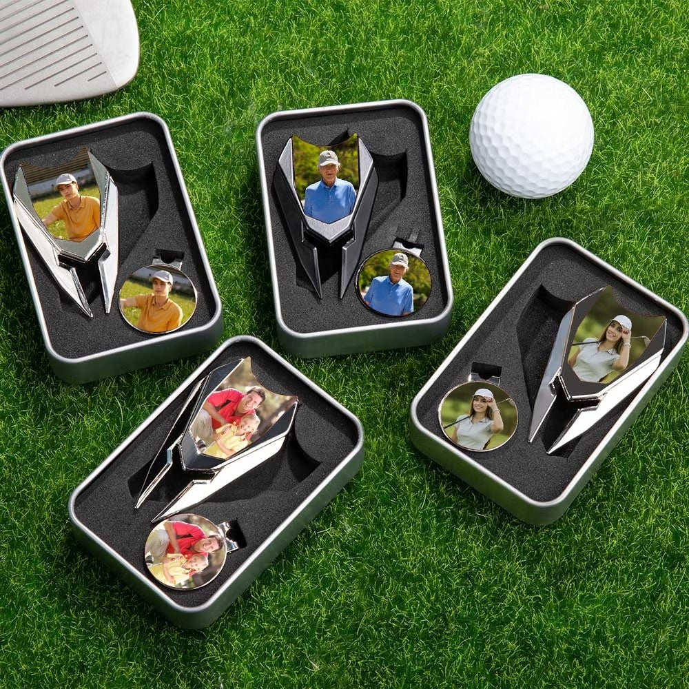 Multiple personalized photo golf divot tool and ball marker gift sets displayed on grass
