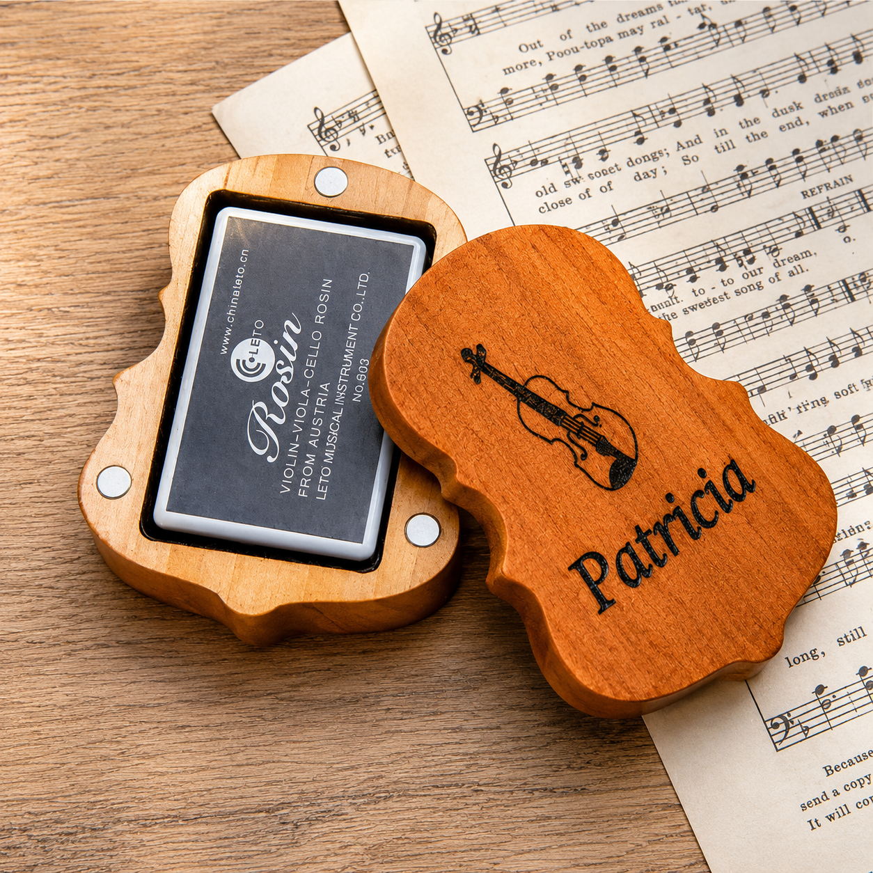 Personalized wooden violin rosin box with custom engraved name and violin design, open to reveal premium rosin on a dark walnut wood surface.