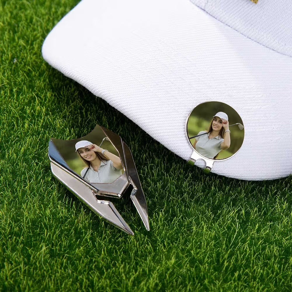 Personalized golf ball marker attached to white golf cap with custom photo divot tool