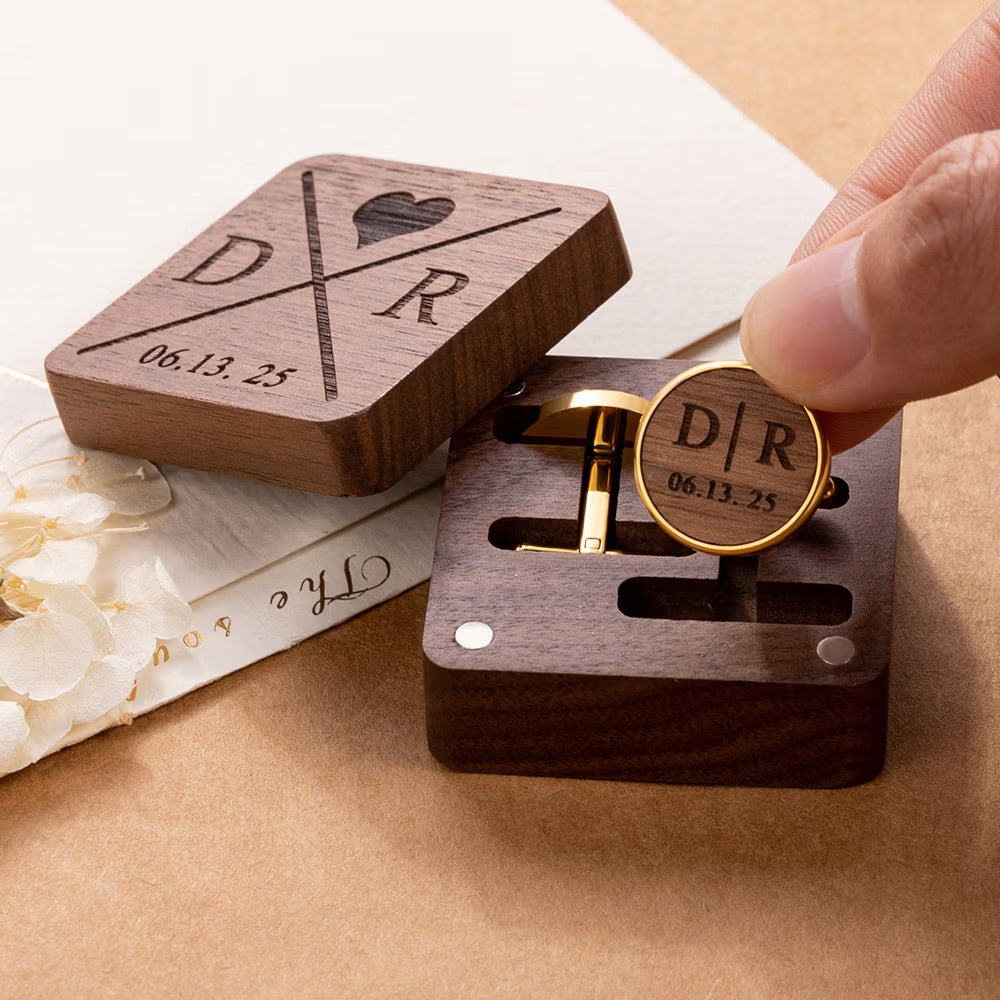 Hand displaying custom engraved cufflink with matching personalized wooden gift box