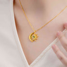 Dainty gold moon and sun birthstone necklace worn with white top
