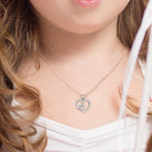 Girl wearing a personalized unicorn heart necklace