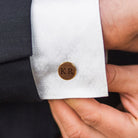 Personalized wooden initial cufflink worn with white dress shirt and black suit
