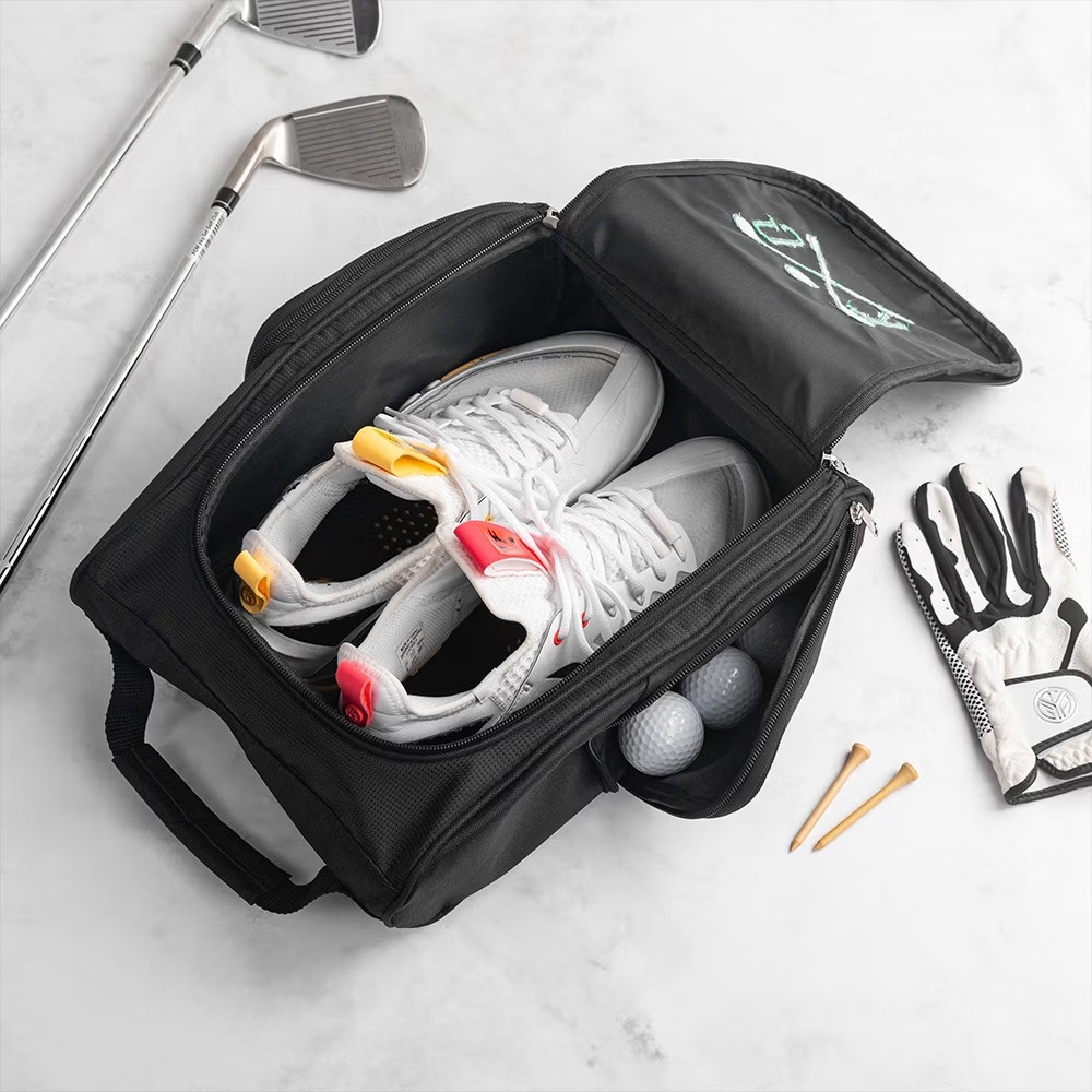 Open golf shoe bag showing spacious interior with golf shoes and accessories