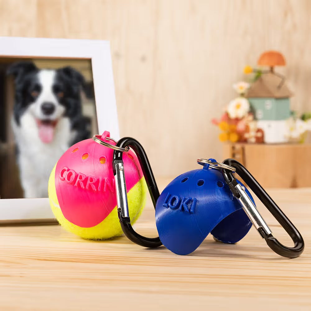 Personalized dog tennis ball holders in pink and blue with carabiner clips