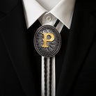 Custom bolo tie with gold letter P on ornate silver pendant, worn with black suit and white shirt