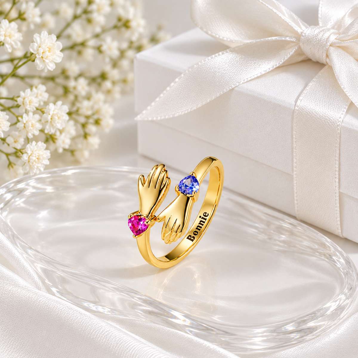 Gold personalised hug ring with pink and blue heart-shaped birthstones and Bonnie engraving.