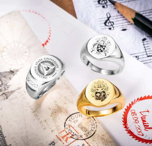 Personalized family crest signet rings displayed with heraldic artwork and engraving designs