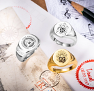 Personalized family crest signet rings displayed with heraldic artwork and engraving designs