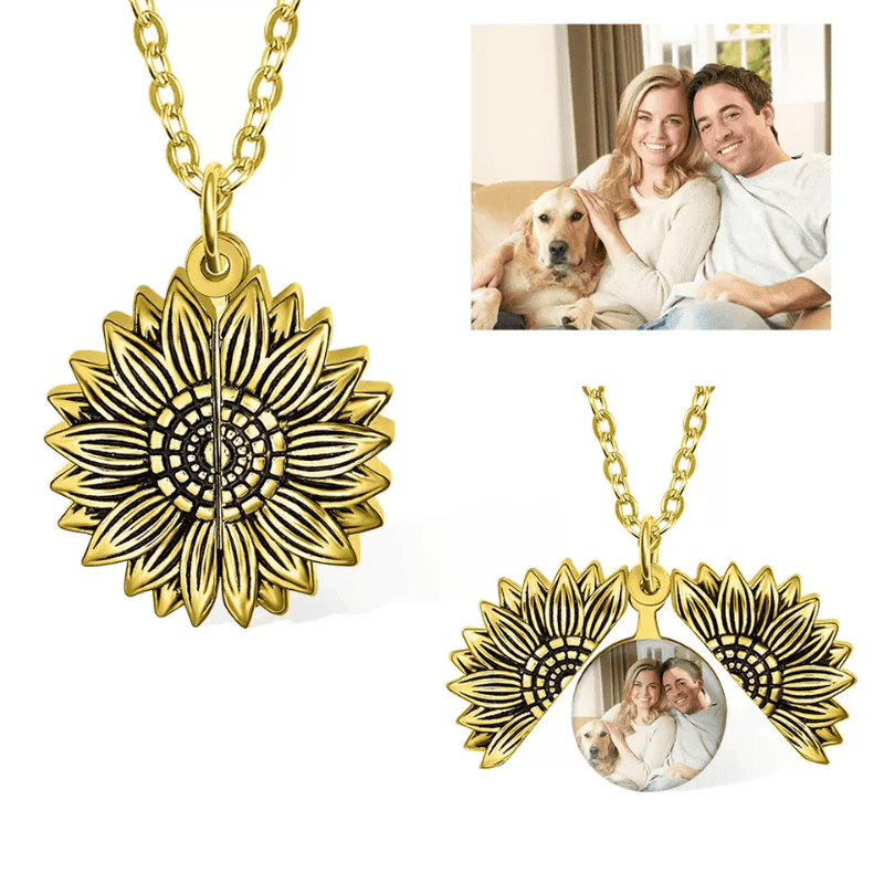 Gold sunflower locket necklace open to show a personalized photo, with a couple and their dog.
