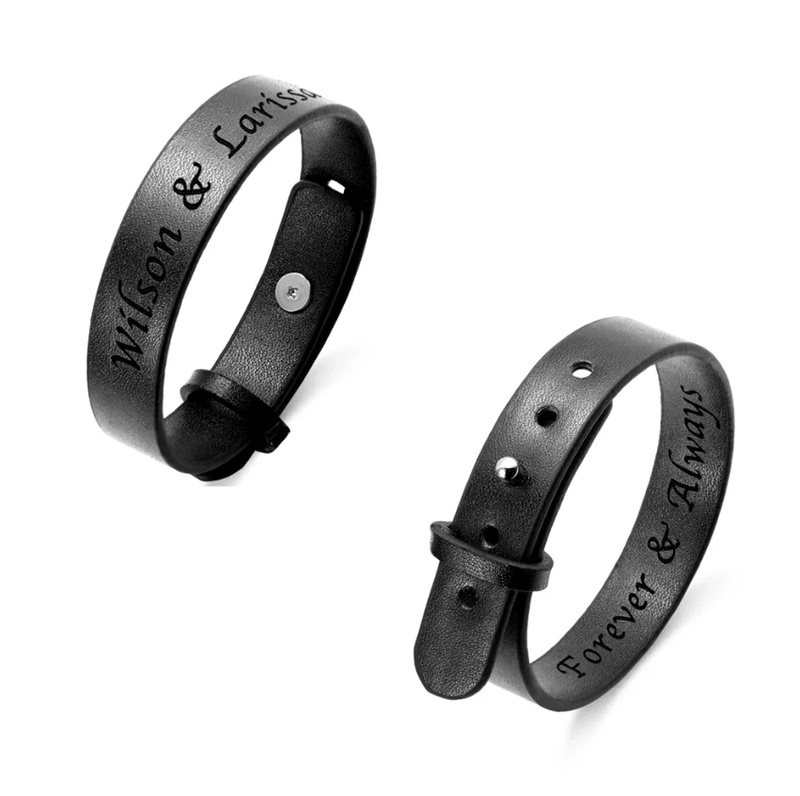 Custom black leather bracelets with engraved names and messages, featuring a buckle and snap closure design