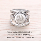 A sterling silver stackable ring set with a central monogrammed disc featuring the initials "TME," surrounded by sparkling cubic zirconia, with dimensions provided.