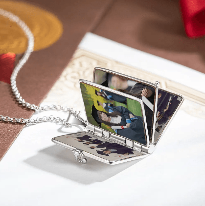 Open Personalized Graduation Album Necklace in silver, showcasing custom graduation photos inside, ideal as a memorable and personalized graduation gift.
