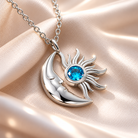 Silver crescent moon and sun necklace with blue birthstone