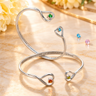Personalized double birthstone heart adjustable silver bangle bracelets with colorful gemstones and custom engraved grandmother and granddaughter message, meaningful family jewelry gift.