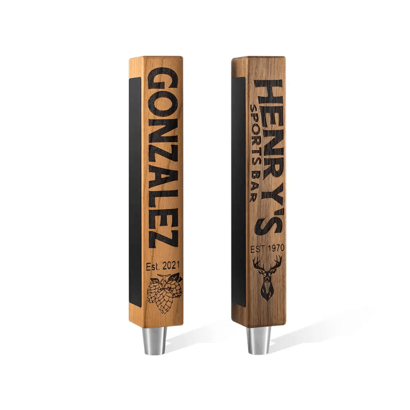 Two custom beer tap handles with personalized engraving and chalkboard decals, featuring "Gonzalez" with a hop graphic and "Henry's Sports Bar" with a deer logo.