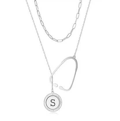 Layered silver necklace with a stethoscope pendant and a custom initial charm, displayed against a white background.