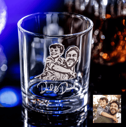 Custom engraved whiskey glass with a photo of a father and son labeled "Dad & Daniel," featuring a joyful moment between them.
