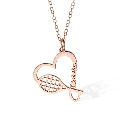 Rose gold tennis racket necklace with a heart charm, customized with the name "Charlotta." Perfect sports jewelry gift for tennis enthusiasts and athletes.
