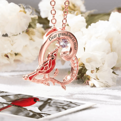Rose gold 'Dear grandma is near' engraved cardinal necklace with purple gemstone.