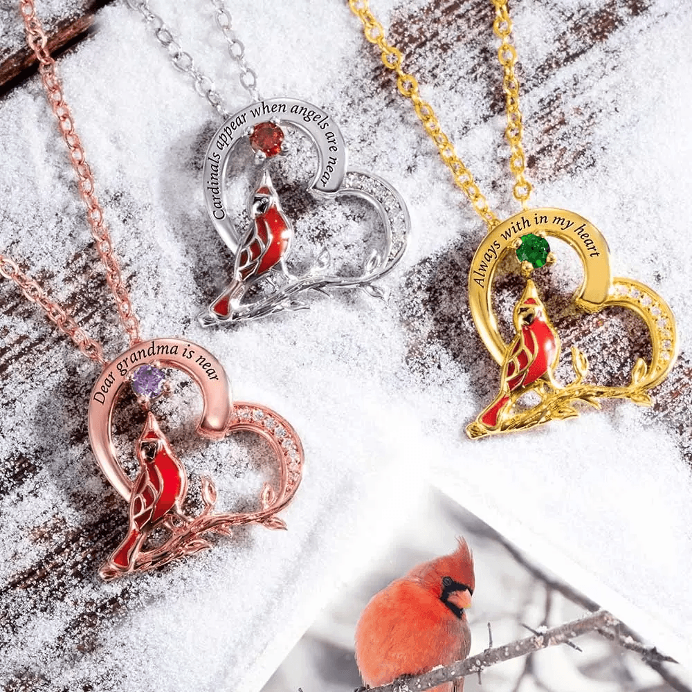 Assortment of cardinal necklaces in gold, silver, and rose gold with inscriptions and gemstones on snow.