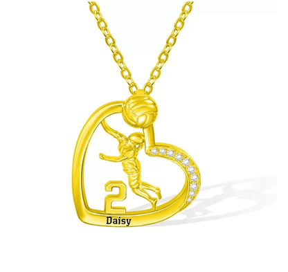 A gold heart-shaped volleyball-themed necklace featuring a player, the number 2, and the name Daisy, with a diamond-accented curve.