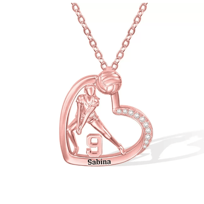 A rose gold necklace pendant featuring a volleyball player inside a heart shape, with the number 9 and the name "Sabina" engraved at the bottom.