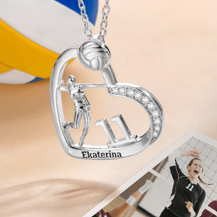 A silver heart-shaped volleyball-themed necklace featuring a player, the number 11, and the name Ekaterina, with volleyball images in the background.