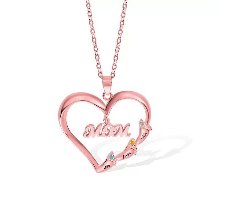 A rose gold heart-shaped necklace with "MOM" inscribed, featuring three names (Lily, Emily, Eddie) adorned with colorful gemstones around the edge.