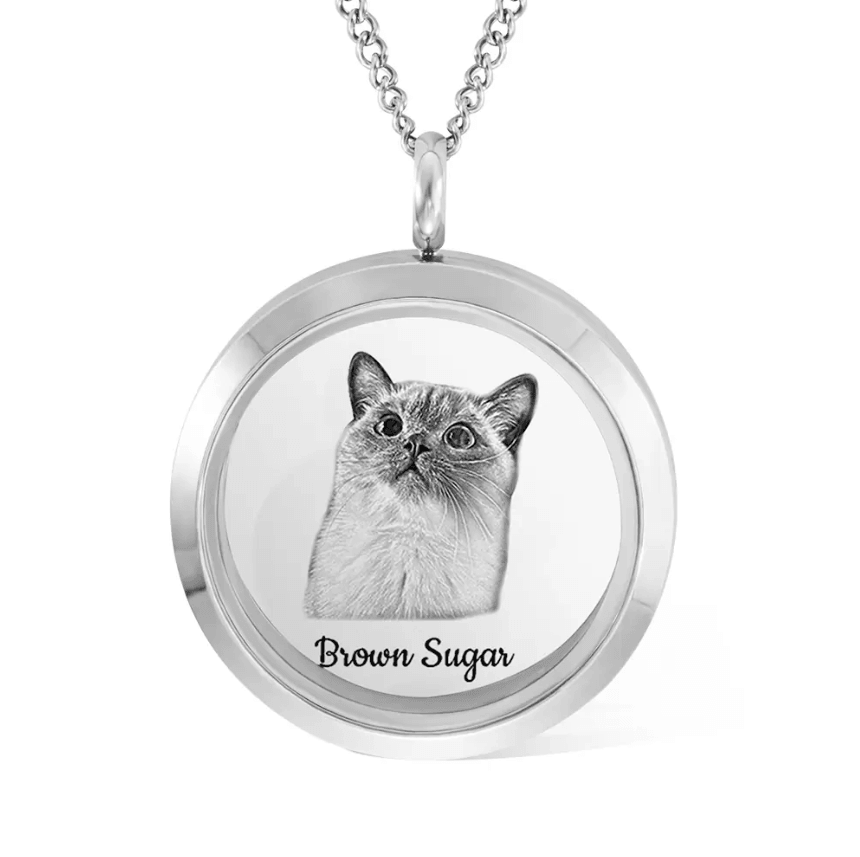Silver locket necklace with a black and white image of a cat named 'Brown Sugar' engraved on the front