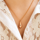 Rose gold personalized teardrop urn necklace being worn