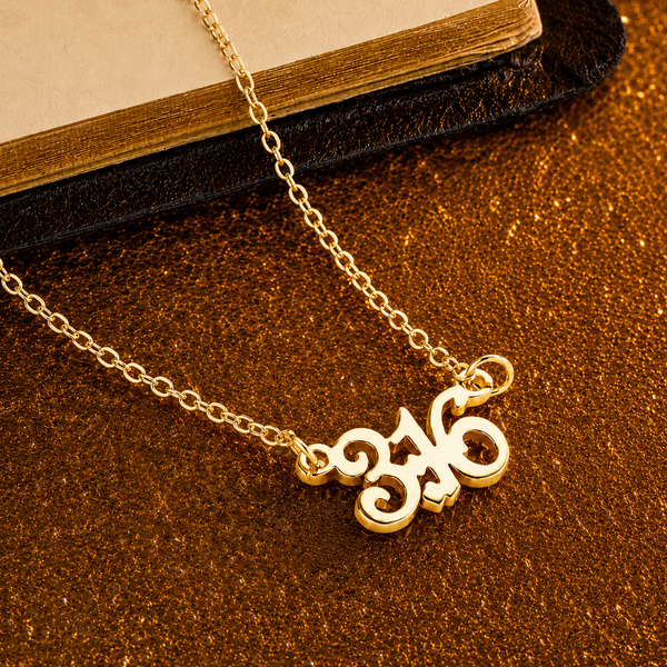 Gold necklace with ornate initial pendant, perfect for personalized gifts and special occasions.