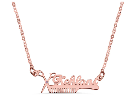 Rose gold personalized hairdresser necklace with scissors and comb pendant and the name 'Kehlani'.