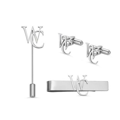 A set of silver men's accessories featuring a tie clip, lapel pin, and cufflinks with an interlocking "WC" monogram design.