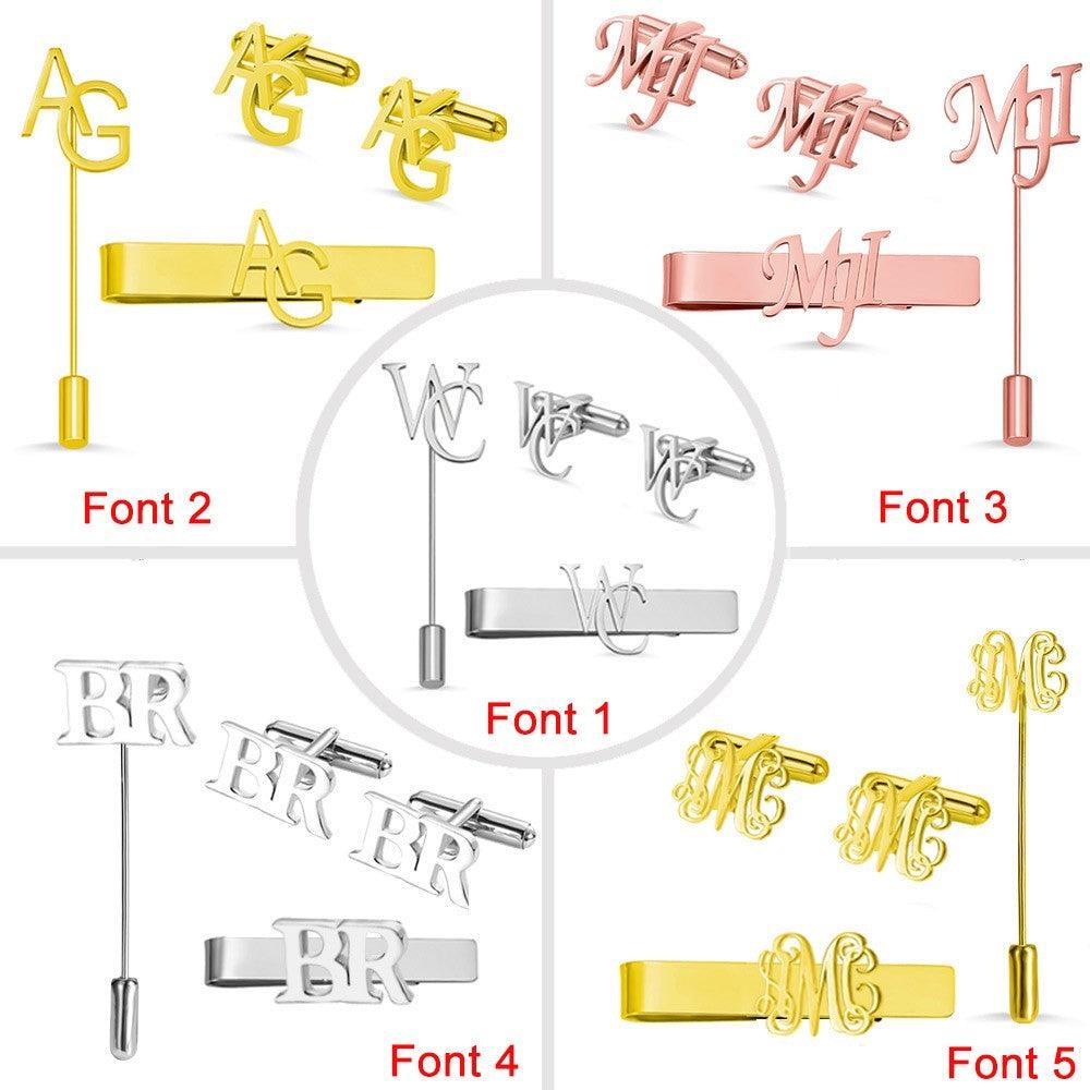 A selection of men's accessories sets with different monogram designs in various fonts. Includes tie clips, lapel pins, and cufflinks in gold, silver, and rose gold.