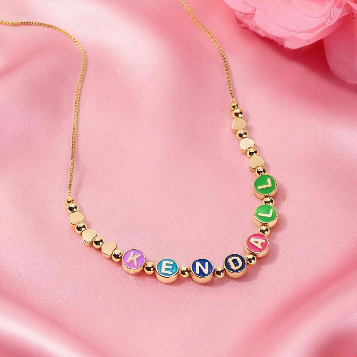 Custom name necklace with colorful enamel alphabet beads and gold heart accents