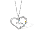 A silver heart-shaped necklace with "Nana" inscribed in the center, featuring eight names (Lily, Emily, Eddie, etc.) adorned with colorful gemstones around the edge.