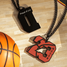 Two basketball-themed pendants on chains, one featuring the number "23" with the name "Mason" and the other with the letter "D" engraved with "Proud of you," on a wooden floor next to a basketball.